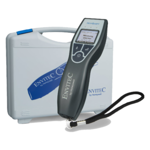 Close-up of a handheld AlcoQuant breathalyzer resting on a medical analyzer with a black strap nearby.